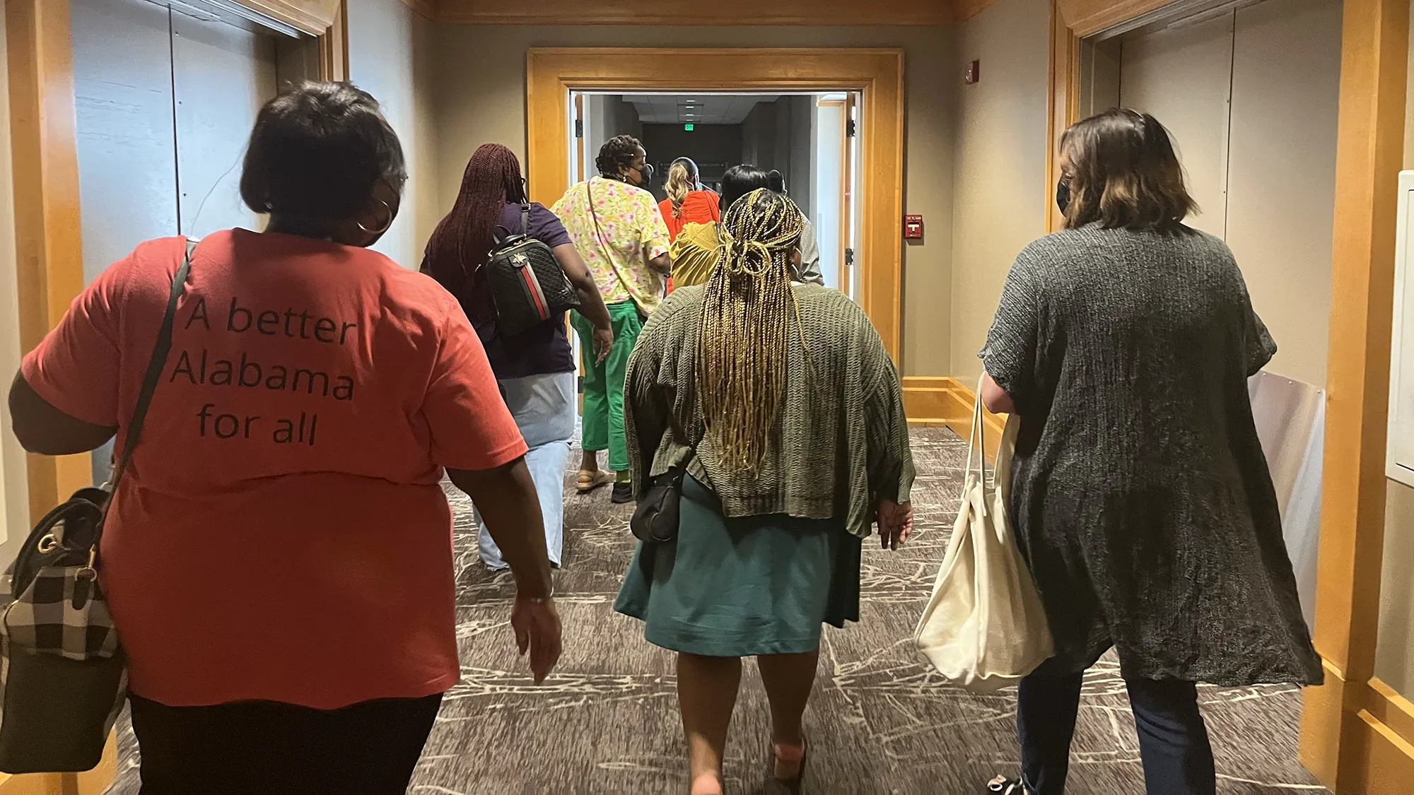 oral health advocates walk through hallway of Alabama State House